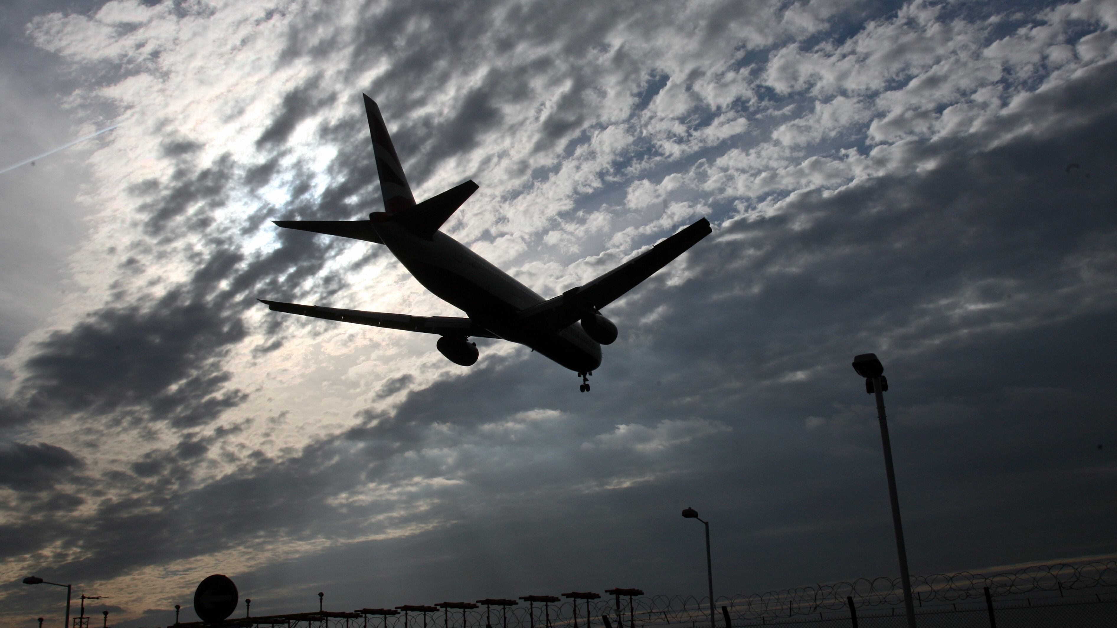 LONDON - MARCH 16: A plane comes into land at Heathrow Airport on March 16, 2007 in London. A US government agency has announced that winter in the Northern Hemisphere this year has been the warmest since records began. Air travel continues to be a major source of debate; attempts to slow climate change with radical policies are being tabled by scientists and politicians. Hybrid buses, which use a combination of diesel and electric power, are said to be central to the Mayor and Transport of London's plans for a cleaner, greener bus fleet in London, and aim to start cutting the capital's Carbon Dioxide emissions helping to tackle climate change.