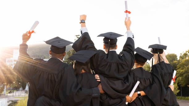 Graduation, group and back view of students celebrate education success. Behind of excited graduates at campus celebration for study goals, university award and learning motivation for happy future