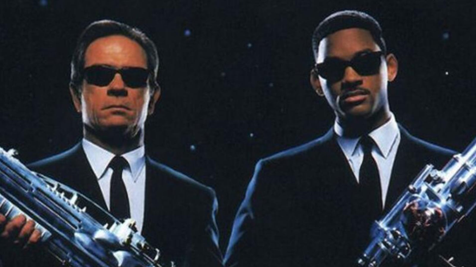 Actores de 'Men in Black' posando en el poster oficial.